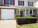 Charming townhome featuring a well-kept front yard, covered entry, and attached one-car garage at 7229 Georges Way, Morrow, GA 30260
