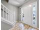 Bright foyer with hardwood floors, a staircase with white railing, and natural light at 7229 Georges Way, Morrow, GA 30260