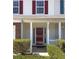 Inviting entryway with white columns, red shutters and manicured shrubs welcomes you home at 7229 Georges Way, Morrow, GA 30260