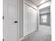 Neutral hallway featuring a closet and doorway leading into a room with natural light at 7229 Georges Way, Morrow, GA 30260