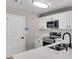 Bright kitchen features white cabinets, light countertops, stainless appliances, and an undermount sink with black faucet at 7229 Georges Way, Morrow, GA 30260