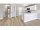 Kitchen with white cabinets, an island with a quartz countertop, and stainless steel appliances at 7229 Georges Way, Morrow, GA 30260