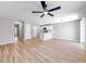 Bright living room with hardwood floors, a modern fan, and a view of the kitchen at 7229 Georges Way, Morrow, GA 30260