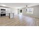 Open concept living area featuring hardwood floors, a kitchen island, and stainless steel appliances at 7229 Georges Way, Morrow, GA 30260