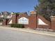 Charming brick signage for Southlake Townhomes adds curb appeal to this community at 7229 Georges Way, Morrow, GA 30260