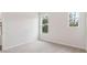 Bright bedroom with plush carpeting and plenty of natural light from two windows at 113 Chestnut Trce # 8, Hapeville, GA 30354