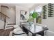 Dining room featuring elegant furnishings, modern lighting, and adjacent staircase at 113 Chestnut Trce # 8, Hapeville, GA 30354