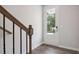 Welcoming entryway featuring wood stairs, modern railing and a glass front door at 113 Chestnut Trce # 8, Hapeville, GA 30354