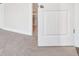 Hallway, white door leading to a bathroom, beige carpet at 113 Chestnut Trce # 8, Hapeville, GA 30354