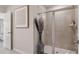 Modern bathroom showcasing a tiled shower with glass door and decorative vase enhancing the room's ambiance at 113 Chestnut Trce # 8, Hapeville, GA 30354