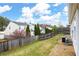 View of the fenced-in backyard with green grass and privacy at 115 Oak Grove Pl, Acworth, GA 30102