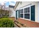 Close-up view of a home's entrance, highlighting its well-kept garden and brick accents beneath the window at 115 Oak Grove Pl, Acworth, GA 30102