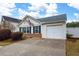 Inviting single-story home with an attached garage and neatly landscaped front yard with flowering bushes at 115 Oak Grove Pl, Acworth, GA 30102