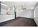 Open-concept living room with dark wood flooring and a partial wall providing a view into the kitchen at 115 Oak Grove Pl, Acworth, GA 30102