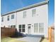 Townhome backyard with a concrete patio, fenced yard, and a view of the home's exterior at 2698 Ne Almand Ne Ln, Conyers, GA 30013