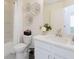 Well-lit bathroom featuring a white vanity, framed mirror, and decorative floral accents on the wall at 2698 Ne Almand Ne Ln, Conyers, GA 30013