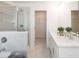 Bathroom featuring dual sinks, a glass shower, and modern fixtures for a luxurious feel at 2698 Ne Almand Ne Ln, Conyers, GA 30013