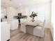 Bright dining area featuring wood floors, a modern table setting, and large windows with natural light at 2698 Ne Almand Ne Ln, Conyers, GA 30013