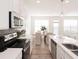 Well-lit kitchen with stainless appliances, white cabinetry, subway tile backsplash and hardwood floors at 2698 Ne Almand Ne Ln, Conyers, GA 30013