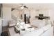 Stylish living room with an open layout featuring a staircase, modern furniture, and an adjacent kitchen at 2698 Ne Almand Ne Ln, Conyers, GA 30013