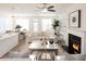 Open-concept living space with modern decor, fireplace, dining area, and a view of the kitchen at 2698 Ne Almand Ne Ln, Conyers, GA 30013