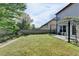 Spacious backyard with lush greenery, a patio area, and a charming pergola, perfect for outdoor enjoyment at 3517 Harvest Ridge Ln, Buford, GA 30519