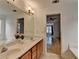 Bathroom featuring double sink, tiled flooring, large mirror and access to living area at 3517 Harvest Ridge Ln, Buford, GA 30519