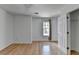 Bright bedroom with hardwood floors, window, closet and a fresh coat of white paint at 3517 Harvest Ridge Ln, Buford, GA 30519