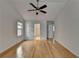 Spacious bedroom featuring vaulted ceilings, ceiling fan, hardwood floors and access to ensuite at 3517 Harvest Ridge Ln, Buford, GA 30519