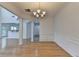 Spacious dining room with hardwood floors, open to kitchen, and wainscoting detail at 3517 Harvest Ridge Ln, Buford, GA 30519