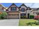 Charming two-story home with a two-car garage, brick accents, and a well-manicured front lawn at 3517 Harvest Ridge Ln, Buford, GA 30519