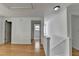 Hallway with hardwood floors leading to bedroom and stairs at 3517 Harvest Ridge Ln, Buford, GA 30519