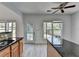 Bright kitchen featuring granite countertops, wood cabinets, and a ceiling fan at 3517 Harvest Ridge Ln, Buford, GA 30519