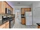 Kitchen with stainless steel appliances and view of hallway to front door at 3517 Harvest Ridge Ln, Buford, GA 30519