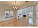 Bright living room with hardwood floors, a fireplace, large windows, and elegant wainscoting details for a cozy space at 3517 Harvest Ridge Ln, Buford, GA 30519