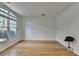 Bright living room featuring a large window, hardwood floors, and neutral paint for a clean and spacious feel at 3517 Harvest Ridge Ln, Buford, GA 30519