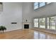 Bright living room with hardwood floors, fireplace, large windows, and vaulted ceilings at 3517 Harvest Ridge Ln, Buford, GA 30519