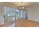 Bright, open-concept living area with hardwood floors, a fireplace, and large windows offering ample natural light at 3517 Harvest Ridge Ln, Buford, GA 30519