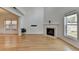 Inviting living room with fireplace, hardwood floors, and large windows at 3517 Harvest Ridge Ln, Buford, GA 30519