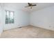 A carpeted bedroom features neutral walls, a ceiling fan, and a window offering natural light at 67 Red Top Cir, Emerson, GA 30137