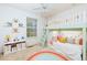 A colorful bedroom features a loft bed, shelving, and a rainbow rug at 67 Red Top Cir, Emerson, GA 30137