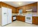 Kitchen with oak cabinets, white appliances, and light countertops at 67 Red Top Cir, Emerson, GA 30137