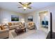 Living room with stylish sofas, area rug, ceiling fan, and an entryway into the dining room at 67 Red Top Cir, Emerson, GA 30137