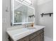 Bright bathroom with white countertop, modern vanity, and a sleek, illuminated mirror reflecting the walk-in shower at 2005 Westbourne Way, Alpharetta, GA 30022