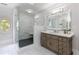 Luxurious bathroom featuring a glass-enclosed shower, oval window and a stylish vanity with illuminated mirror at 2005 Westbourne Way, Alpharetta, GA 30022