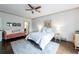 Bedroom showcasing hardwood floors, ceiling fan, and cozy decor with white bedding and pink settee at 2005 Westbourne Way, Alpharetta, GA 30022