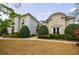 Beautifully landscaped home boasting a classic design with manicured shrubs and lush greenery at 2005 Westbourne Way, Alpharetta, GA 30022