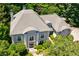 Stately home with lush landscaping, featuring a gray roof and elegant architectural details at 2005 Westbourne Way, Alpharetta, GA 30022