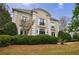 Elegant home with decorative columns, black wrought iron balconies, and lush landscaping at 2005 Westbourne Way, Alpharetta, GA 30022