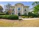 Stunning two-story home featuring manicured landscaping and a grand entrance with decorative columns at 2005 Westbourne Way, Alpharetta, GA 30022